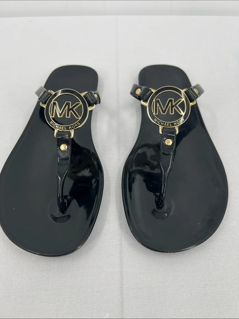 Michael Kors Black Gloss Jelly Logo Thong Sandals with Gold Accents - Picture 1 of 6